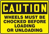 WHEELS MUST BE CHOCKED BEFORE LOADING OR UNLOADING